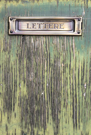 Old Italian mailslot with message "Lettere" (Letters), on old wood door.の写真素材