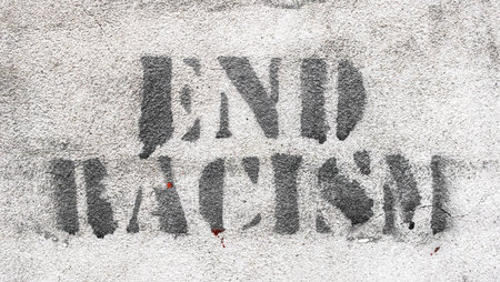 Graffiti on brick wall say - END RACISM. Ideal for concepts and backgrounds.