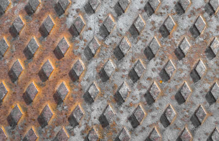 Old rusty drain cover background with diamond pattern.の写真素材