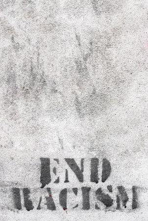 Graffiti on brick wall say - END RACISM. Ideal for concepts and backgrounds.