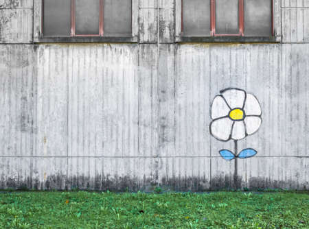White flower drawn on the wall of an old factory. Ideal for conceptsの写真素材