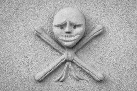 Stone sculpture of the skull with crossbonesの写真素材