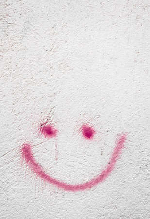 Concrete wall with red smiley, background for many uses.の写真素材