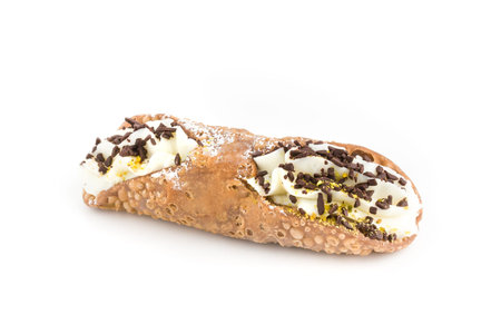 Sicilian cannolo stuffed with ricotta cheese cream, chocolate flakes and pistachio. Typical Sicilian dessert. Italian pastry.の写真素材