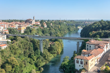 Trezzo sull'Adda (MI), ITALY - September 5, 2020. Aerial view river trezzo and the bridge. Vegetation and industrialization.のeditorial素材