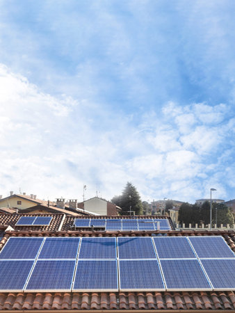 Solar panel on a red roof. Renewable energy source. Present technology. Vertical copy space on sky...