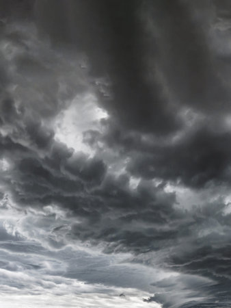 Dark sky with thunderstorm before rainy. Supercell thunderstorm. Dramatic black clouds and motion.の写真素材