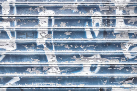 Violet metal shutter with peeling paint. Ideal use for background / wallpaper.