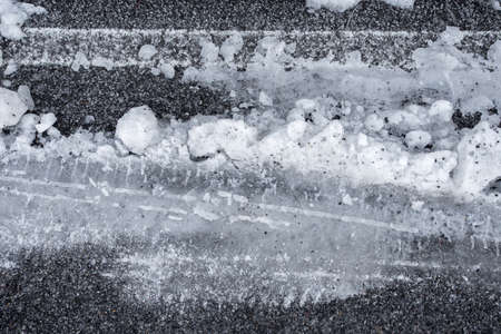 Car tire tracks in fresh snowの写真素材