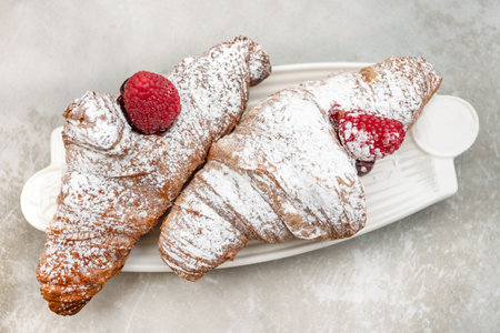 Croissants with jam and berries for Breakfast. Behind, a defocused background.の写真素材