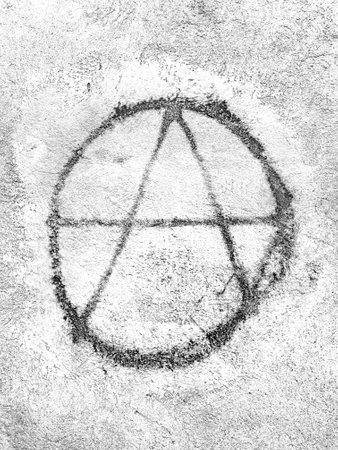 Symbol of anarchy painted on the wall. Graffiti.の写真素材