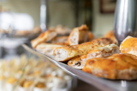 Close-up with slices of focaccia bread and pizza. Homemade focaccia and pizza served as appetizer.Party. Event. Defocused background.の写真素材