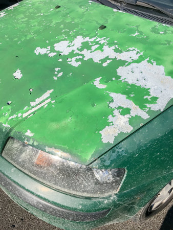 Cracked and peeling paint on an old car for background.の写真素材