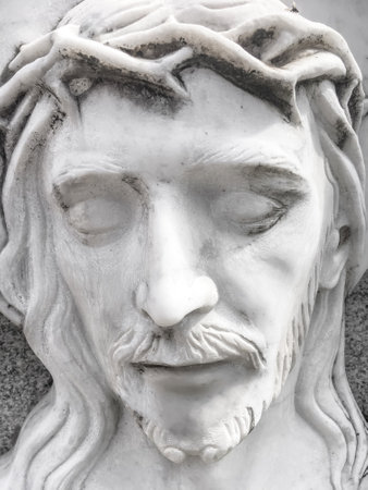 Death of Jesus. White marble statue of the face of the dying Jesus. Concepts and holidays. Easter.の写真素材
