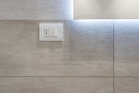 White Light Switch on beige tiles