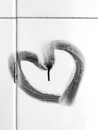 Heart symbol drawn on bathroom tiles. Valentine's day concept.の写真素材