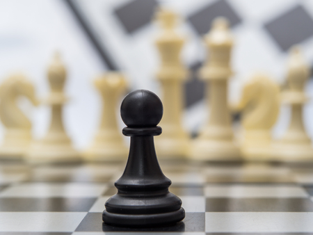 White and black chess pieces on a chessboardの写真素材