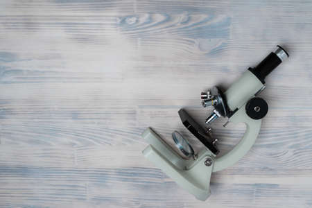 microscope on white wooden backgroundの写真素材