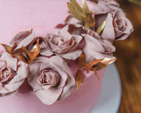 sponge cake covered with pink chocolate roses fondant