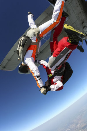 Two parachute jump from an airplane 