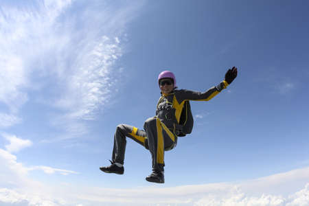 The girl parachutist performs figure freestyle in freefall.の写真素材