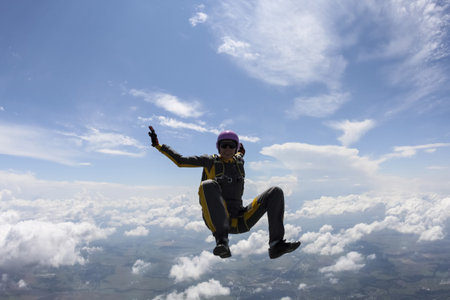 The girl parachutist performs figure freestyle in freefall.の写真素材