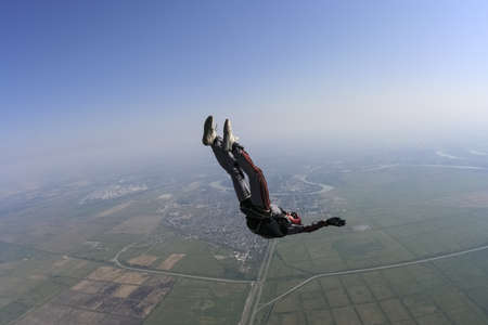Skydiver performs motion on the horizon on the back の写真素材