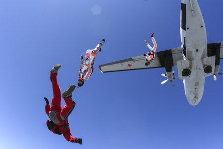 A group of paratroopers jumping out of an airplane の写真素材