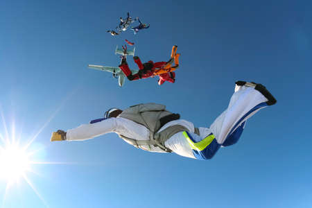 A group of paratroopers jumping out of the plane and build a figure の写真素材