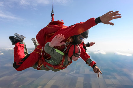Tandem jump  The girl with the instructor in freefall の写真素材
