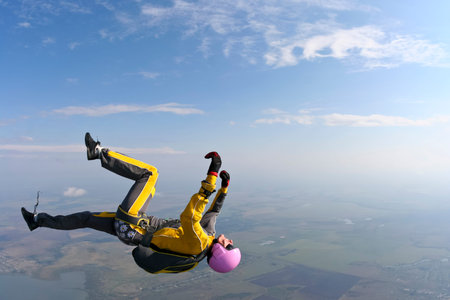 Female skydiver does fall back down.の写真素材