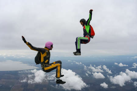Two girls parachutists in free style の写真素材