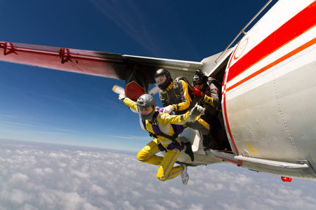 Two girls parachutist jumping out of an airplane 