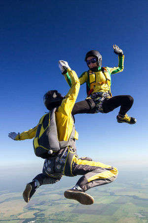Two parachutists girls in free fall 