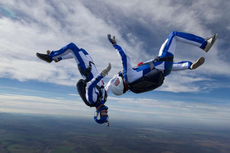 Two skydiver in freefall in the clouds の写真素材