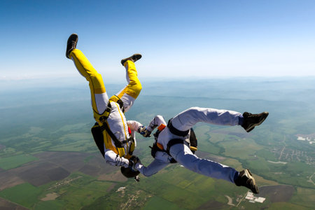 Two skydiver in freefall in the clouds の写真素材