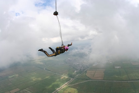 The girl parachutist opens his parachute 