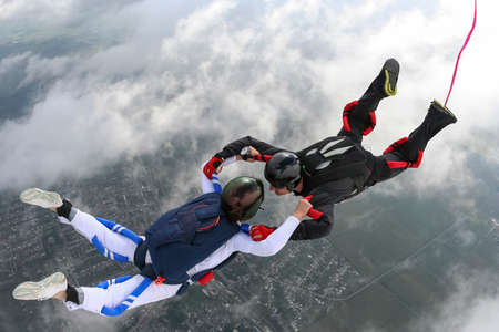Girl and guy skydivers in freefall の写真素材