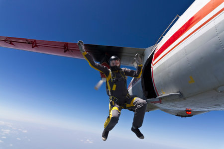 The girl parachutist jumps out of an airplane 