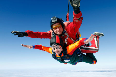 A tandem jump instructor and a passenger in a free fall の写真素材