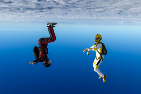 A girl and a guy skydivers perform pieces in free fall.の写真素材