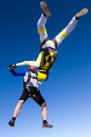 A girl and a guy skydivers perform pieces in free fall.の写真素材