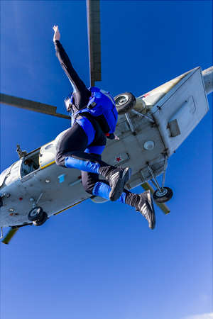The guy parachutist jumps out of an helicopter.の写真素材