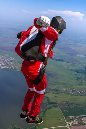 Two sports parachutist build a figure in free fall. Extreme sport concept.の写真素材