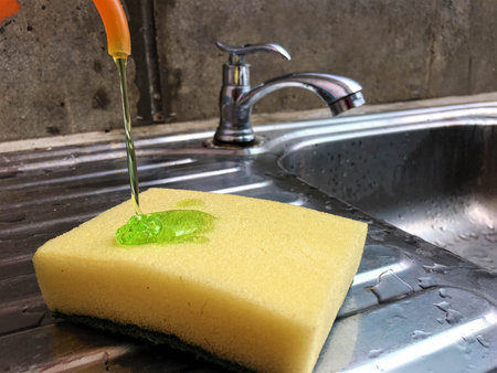 Yellow sponge and Green dishwashing liquidの写真素材