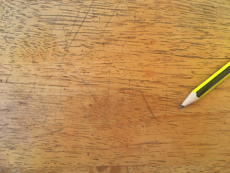 Green and yellow pencil on bright wood floorの写真素材