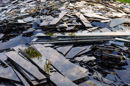 Broken black glass,Heap of mirror fragments,broken black mirror to recycle.の写真素材