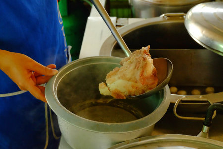 The ladle is drained porksoft in a bowl ,Cooking noodle in thailand,the noodles pork and beef.の写真素材