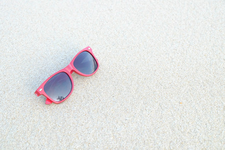 Red sunglasses on the sand at the beach, summer timeの写真素材