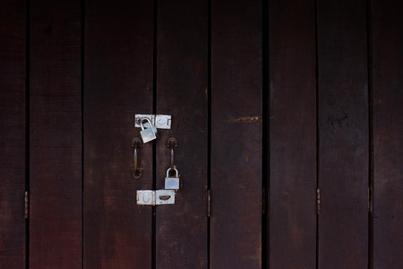 The Brown wooden foldable door and Silver lock.の写真素材